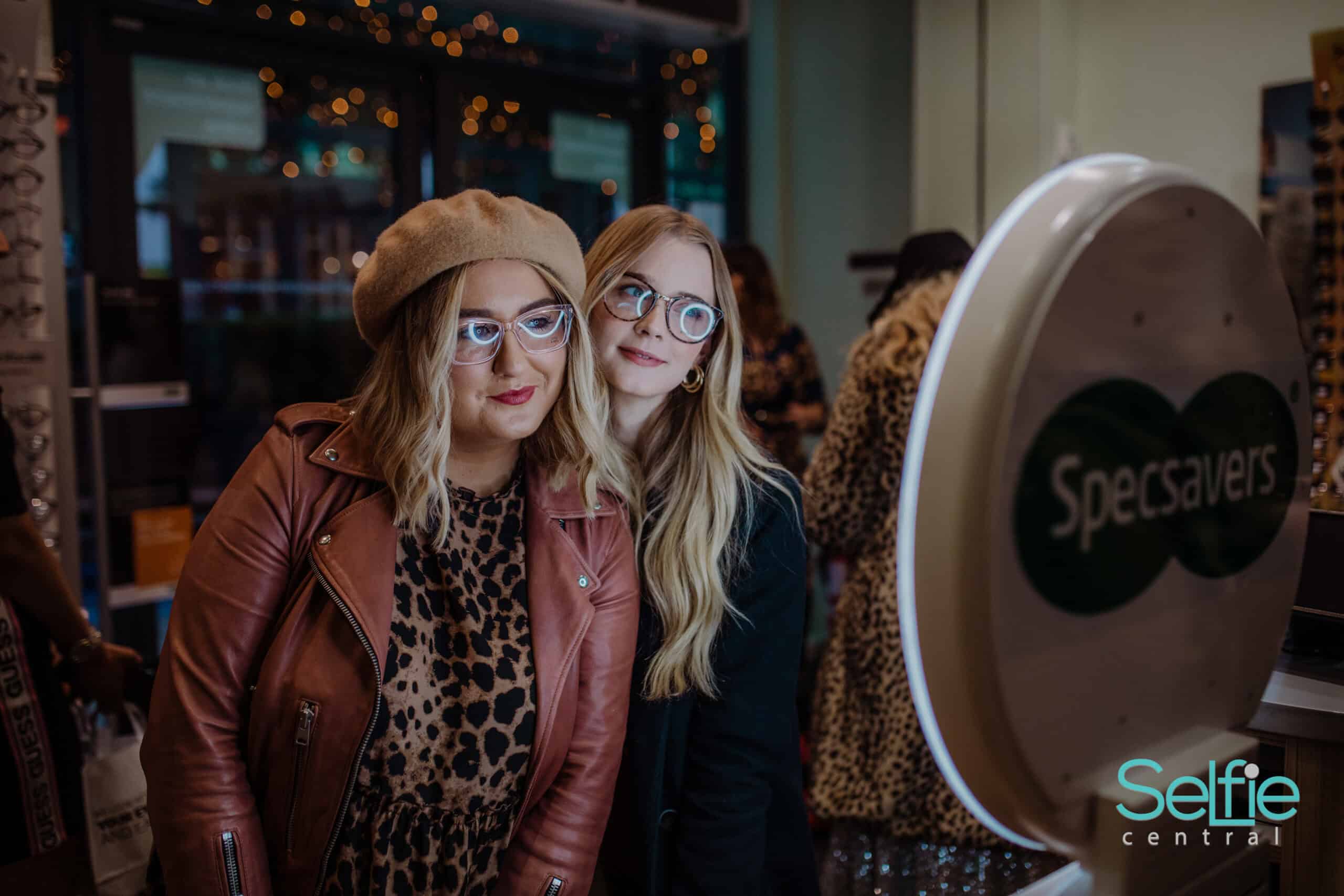 Guests using branded photo booth at corporate event New Zealand